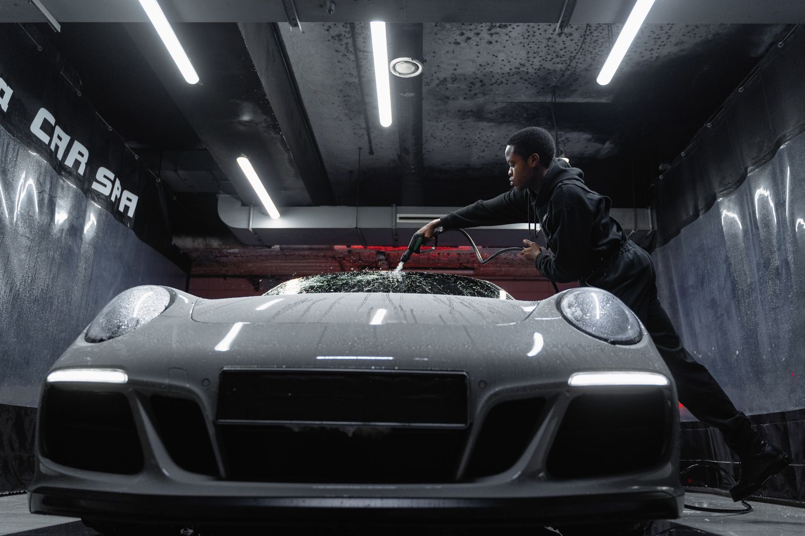 Washing the roof of a Porsche with a wash mitt